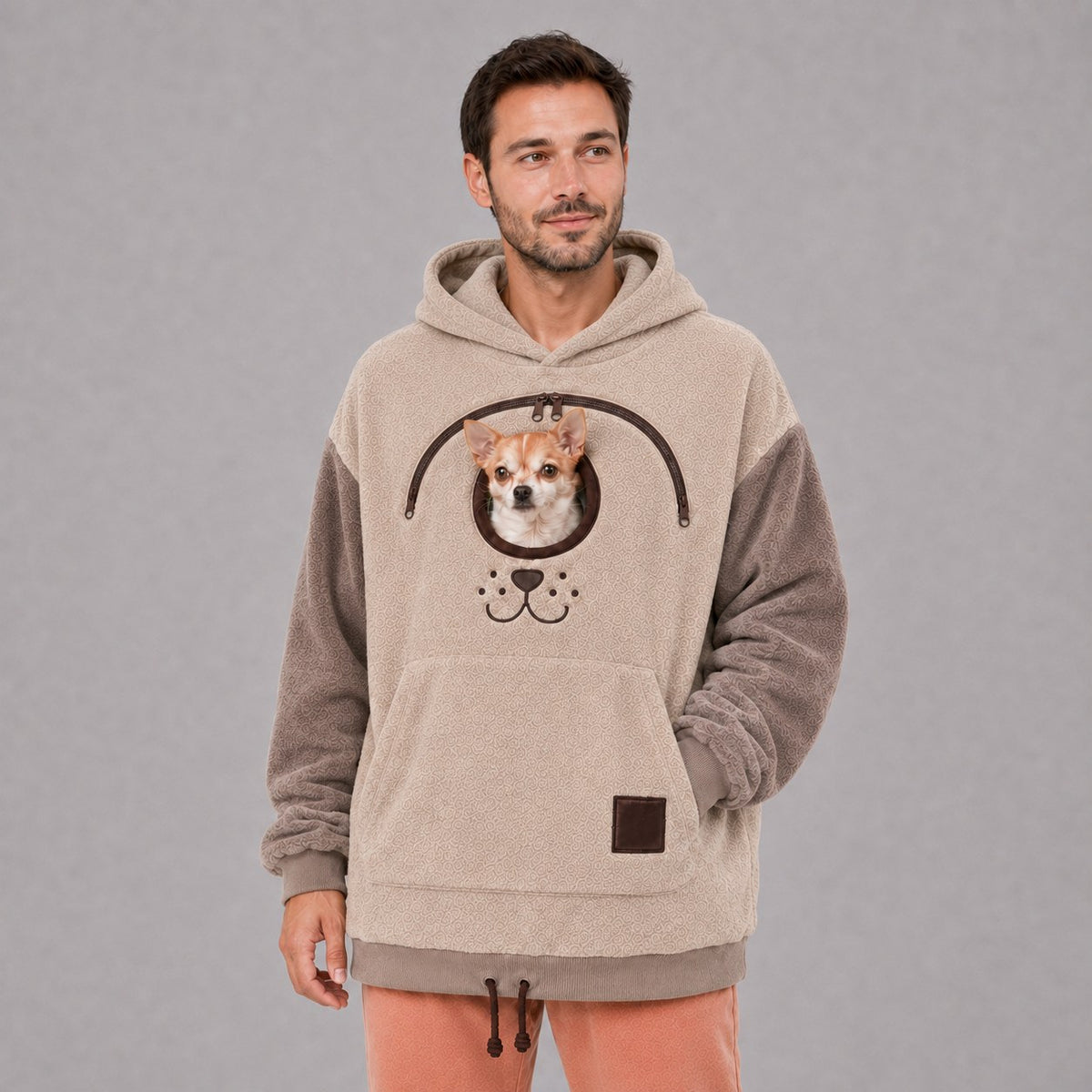 Solis Snuggle Pet Pouch Hoodie in cream worn by a man carrying a small dog