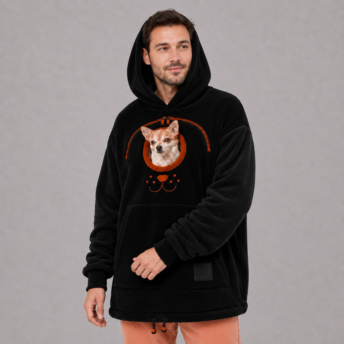 Solis Snuggle Pet Pouch Hoodie in black worn by a man carrying a small dog