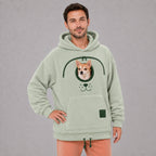 Solis Snuggle Pet Pouch Hoodie in sage green worn by a man carrying a small dog