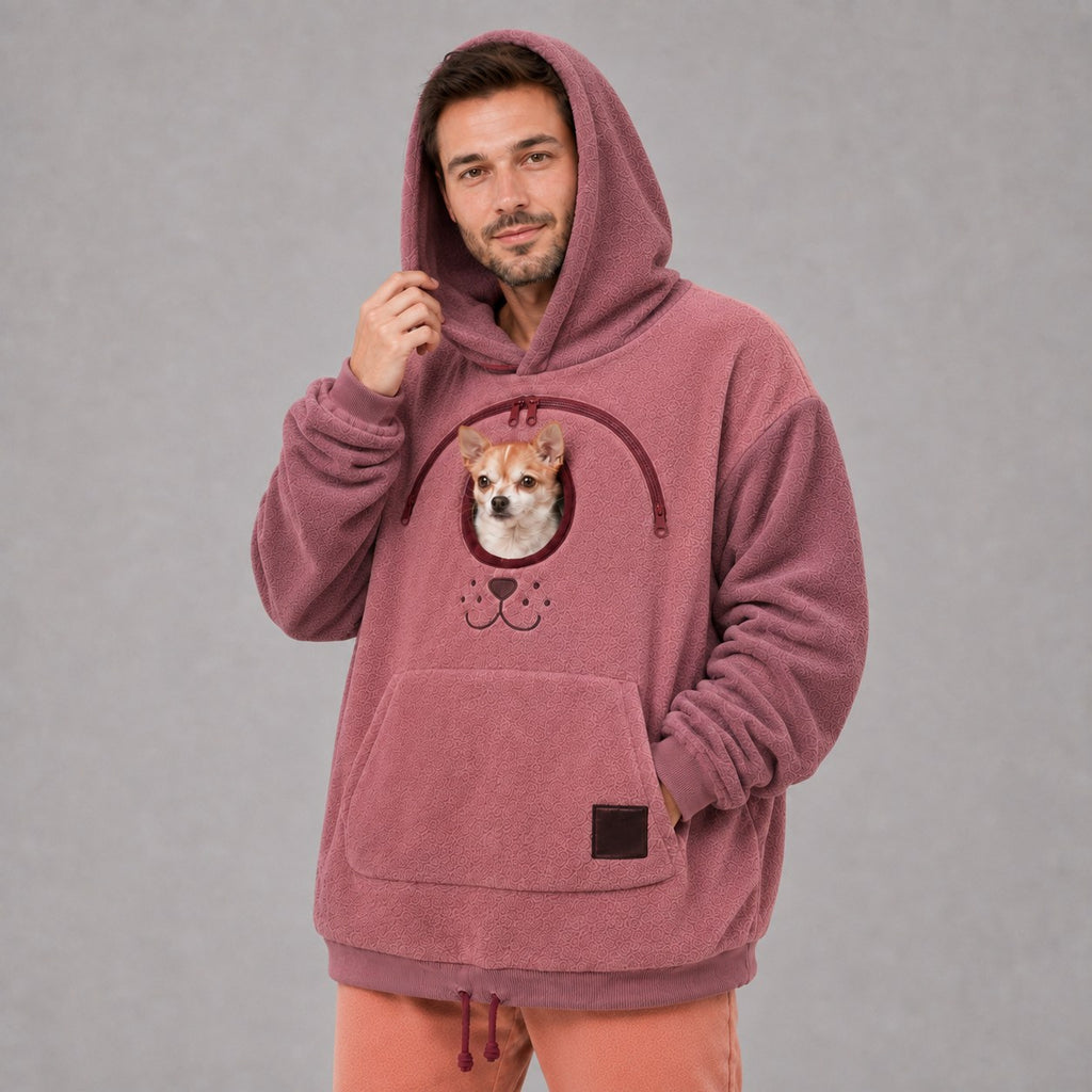 Solis Snuggle Pet Pouch Hoodie in rose pink worn by a man with the hood up