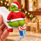 Solis Squeezy — Grinch toothpaste topper squatting on a toothpaste tube, squeezing toothpaste onto a brush
