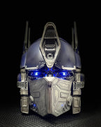 Solis Titan Prime helmet, front view with the battle mask closed and blue eyes lit
