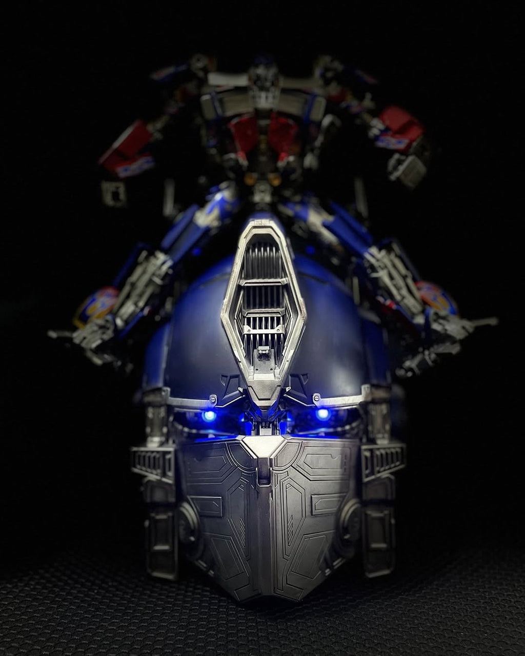 Solis Titan Prime helmet front view with lights on, in a dark room