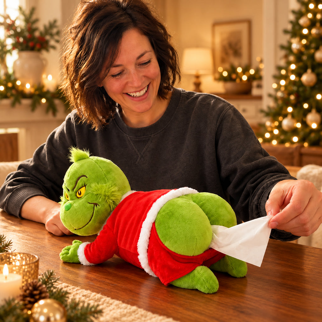 Solis — Grinch tissue box cover lying on a kitchen table with a tissue pulled out of its Santa suit