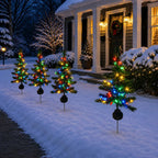 Solis Twinkle Trees — solar Christmas tree lights lining a snowy front walk at night