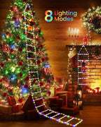 Solis Yuletide Santa Ladder Lights beside a Christmas tree and fireplace, 8 lighting modes