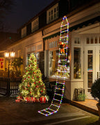 Solis Yuletide Santa Ladder Lights hanging over a doorway beside a lit tree